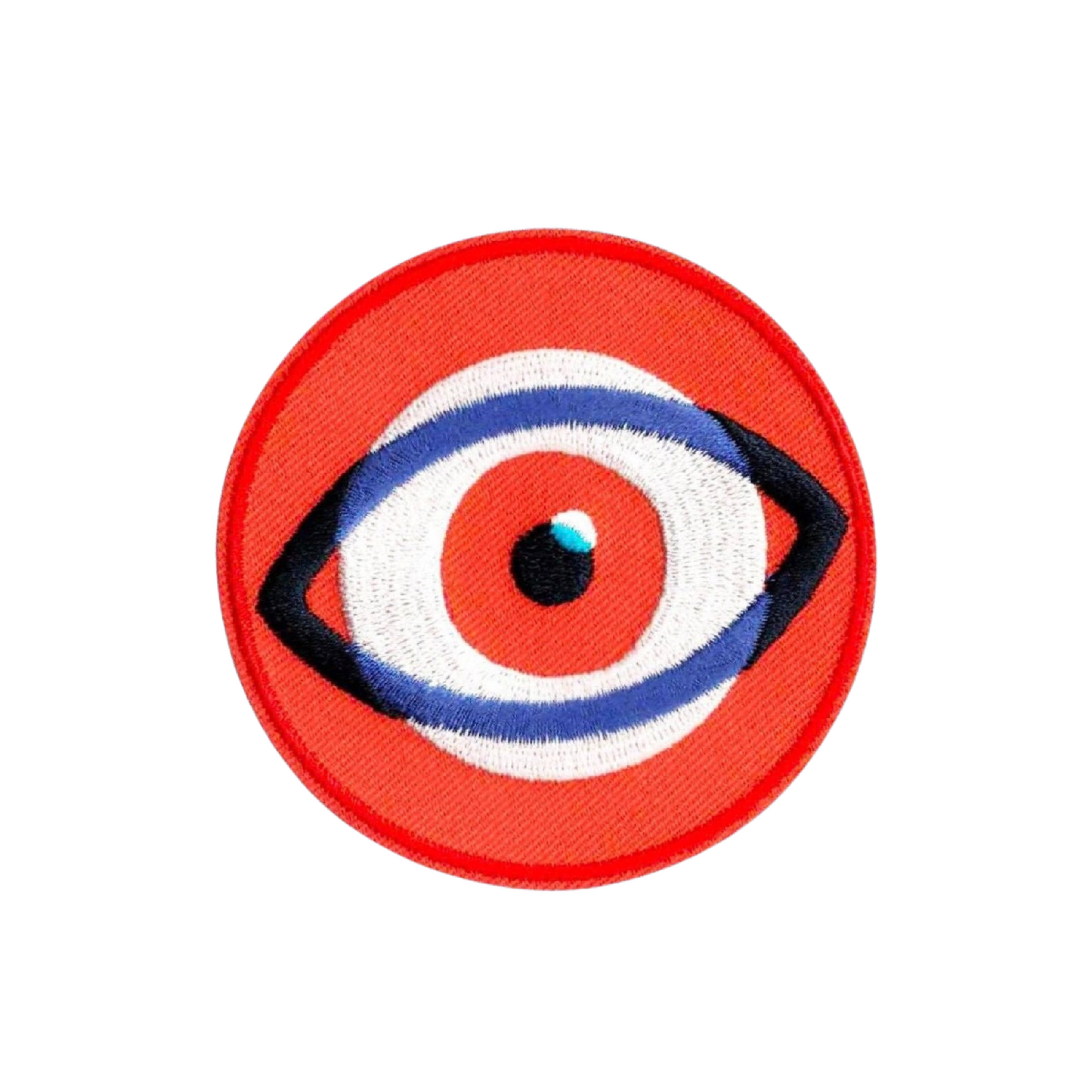Circular patch with an eye design on a red background