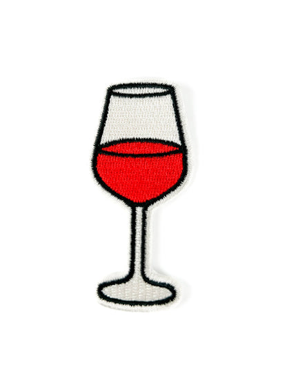 Embroidered patch of a wine glass with red wine on a white background