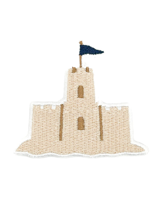 An embroidered patch of a medieval sandcastle with a dark blue flag, on a solid white background.