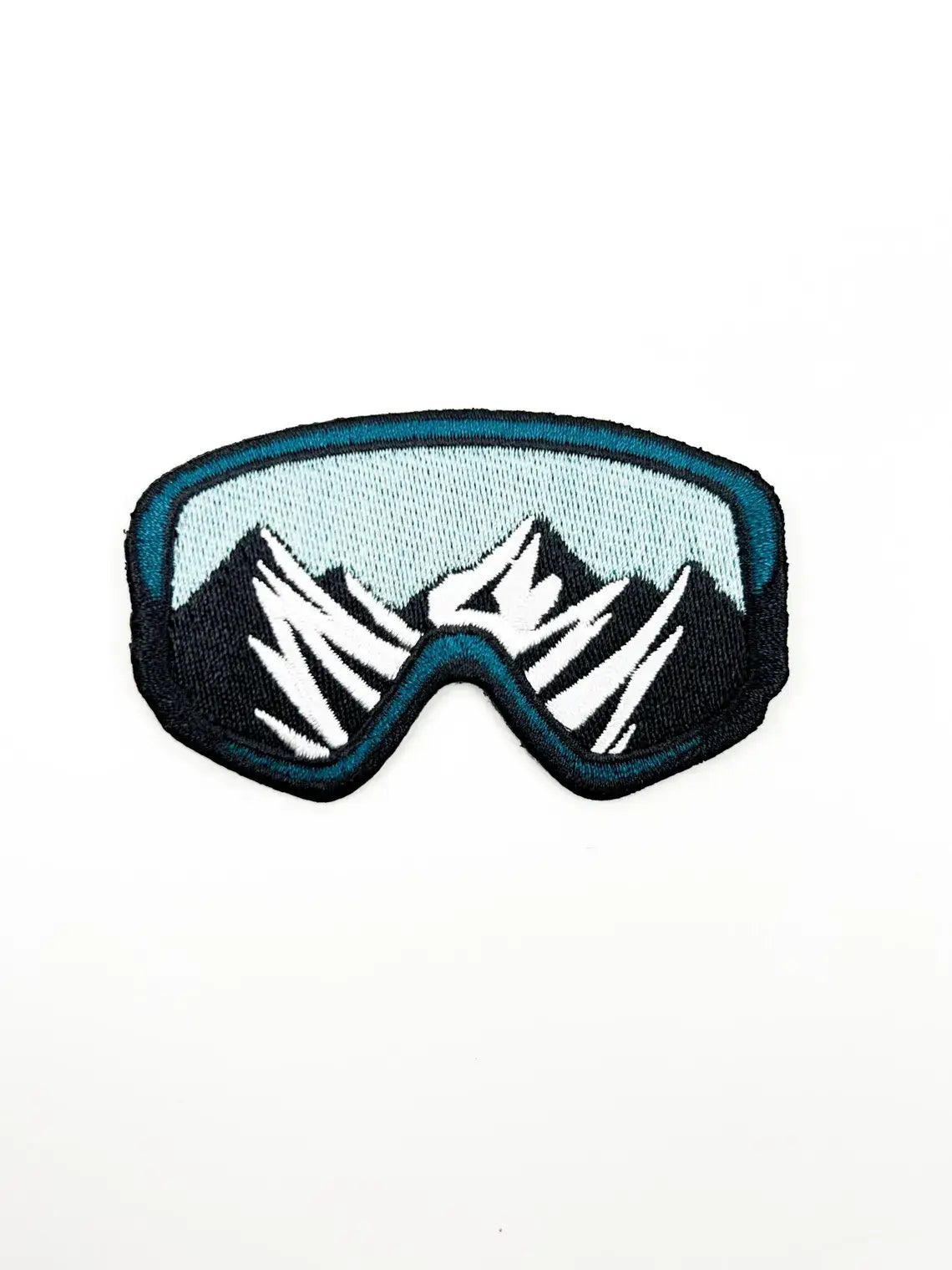 Patch of goggles with mountain design on a white background