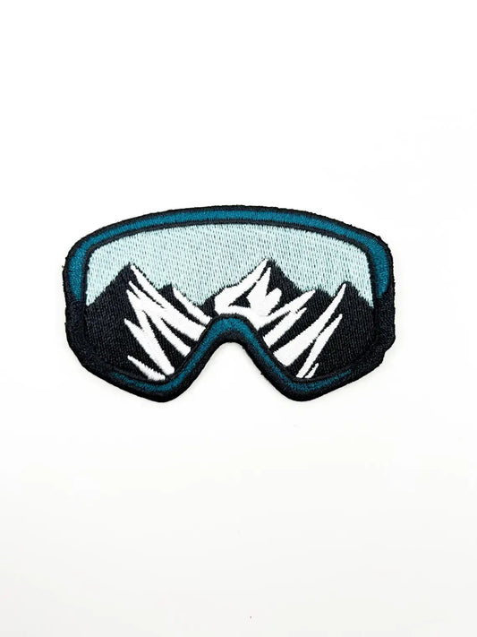 Patch of goggles with mountain design on a white background