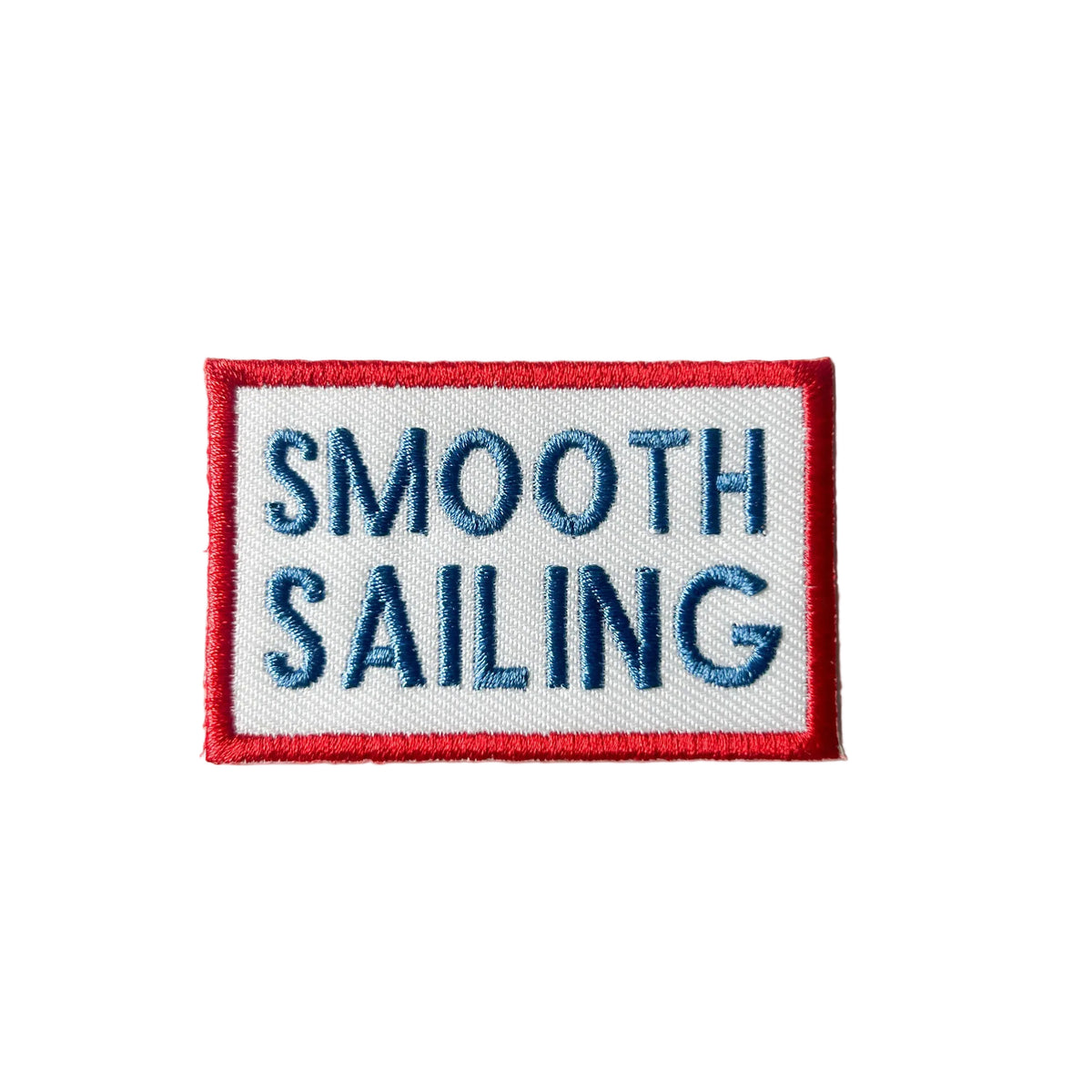 Embroidered patch with 'Smooth Sailing' text on a white background