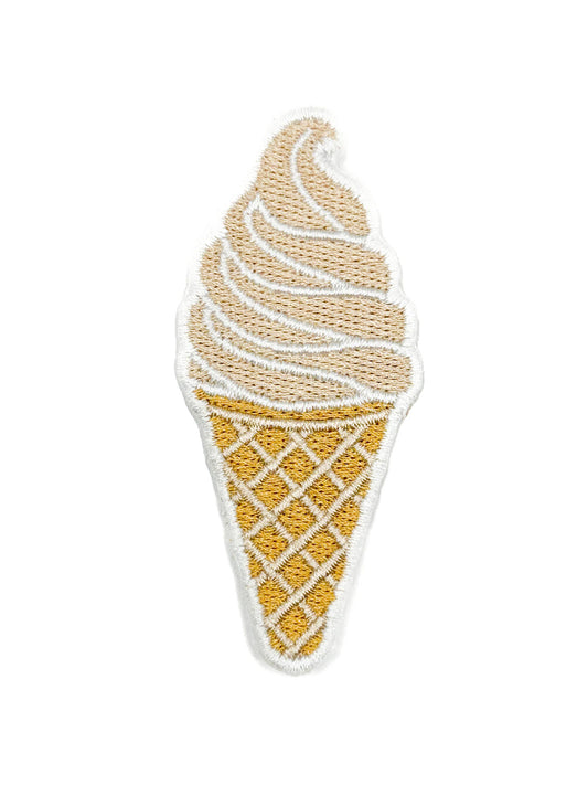 An embroidered ice cream cone patch featuring a golden-yellow waffle cone and swirl of light tan and white frosting, isolated on a white background.