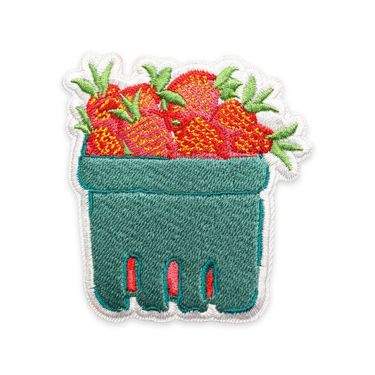 Embroidered patch of a green glove with red strawberries on a white background