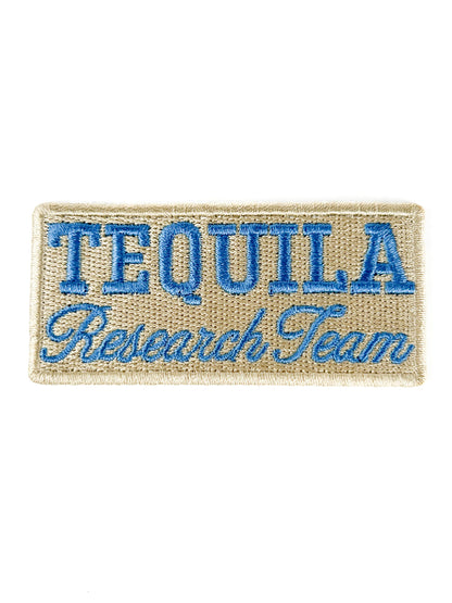 Embroidered patch with 'Tequila Research Team' text on a beige background