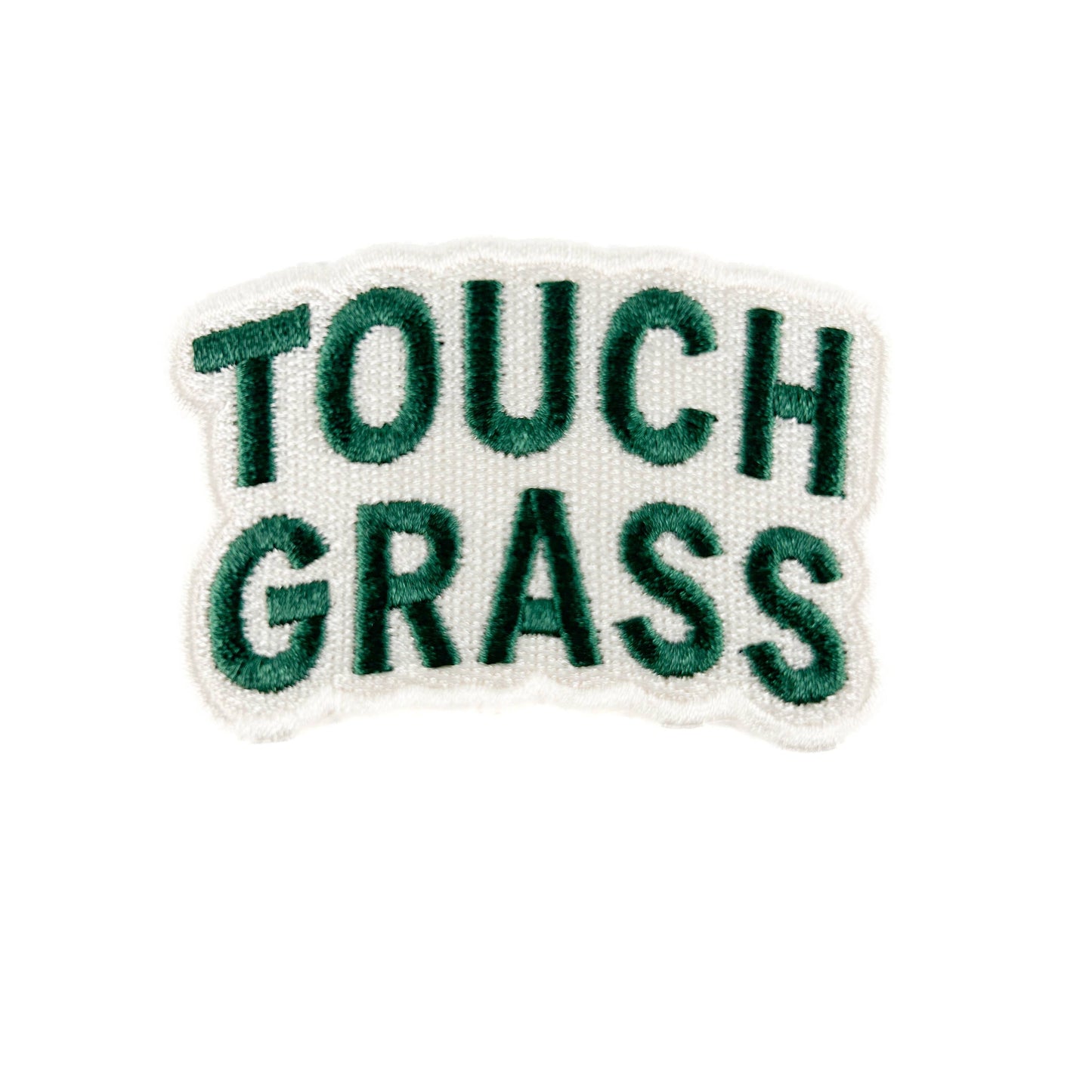 Embroidered patch with 'TOUCH GRASS' text on a white background