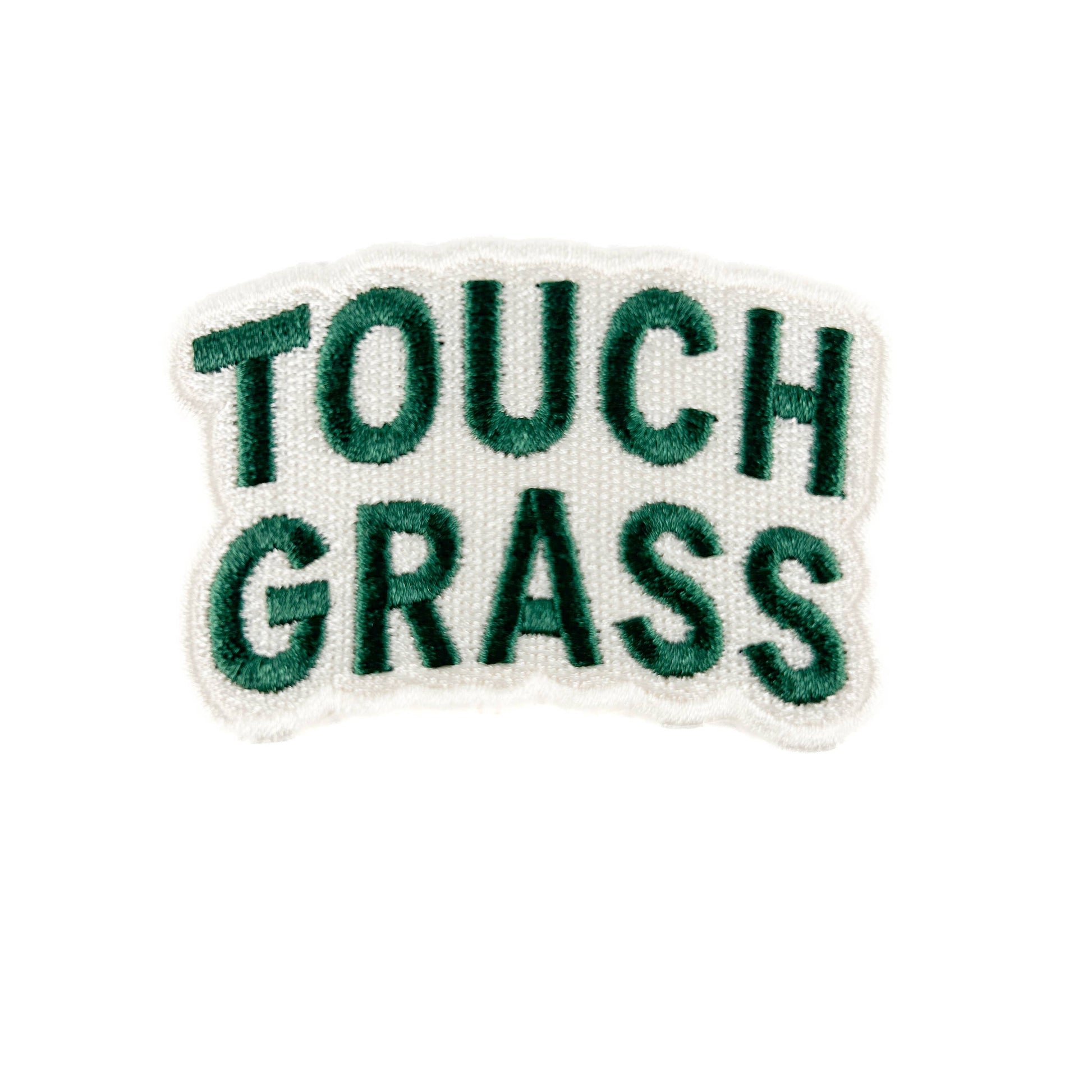 Embroidered patch with 'TOUCH GRASS' text on a white background