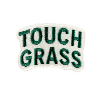 Embroidered patch with 'TOUCH GRASS' text on a white background