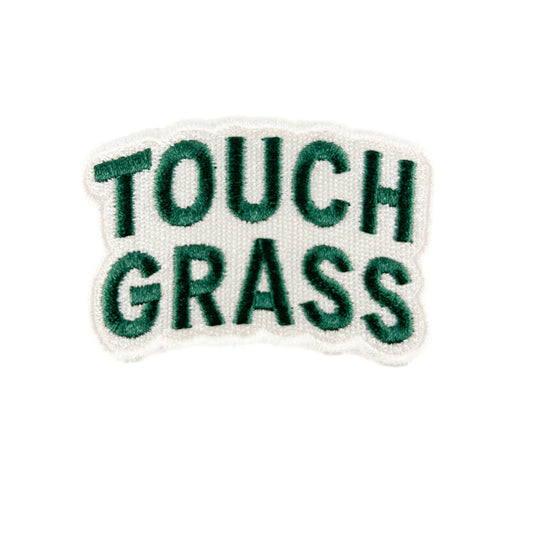 Embroidered patch with 'TOUCH GRASS' text on a white background