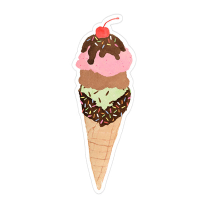 A die-cut sticker of a three-scoop ice cream cone on a plain white background. The ice cream scoops are pink, brown, and light green, topped with chocolate drizzle, sprinkles, and a red cherry.