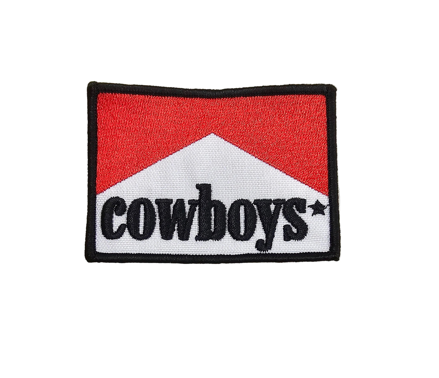 Embroidered patch with 'cowboys' text on a red and white background, placed on a textured light gray surface.