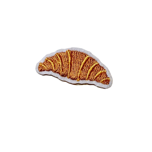 Croissant patch on a light gray background