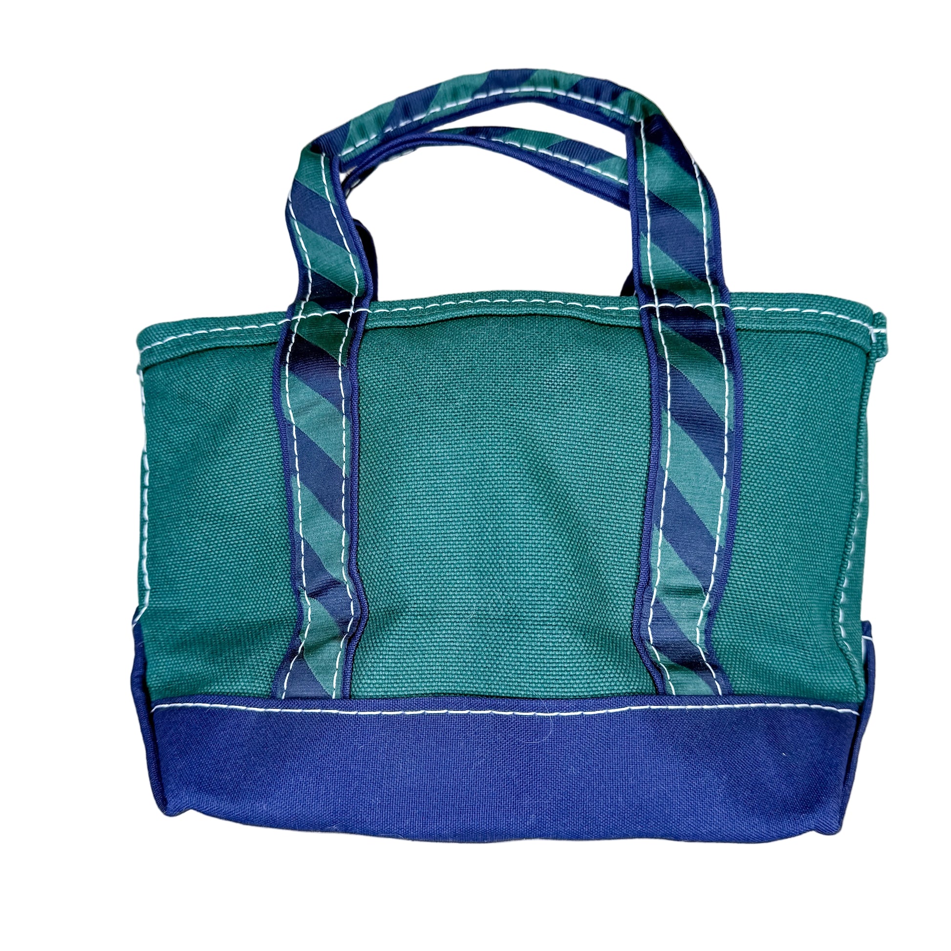 Green and blue tote bag on a textured white surface