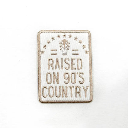 Patch with 'Raised on 90's Country' text on a white background