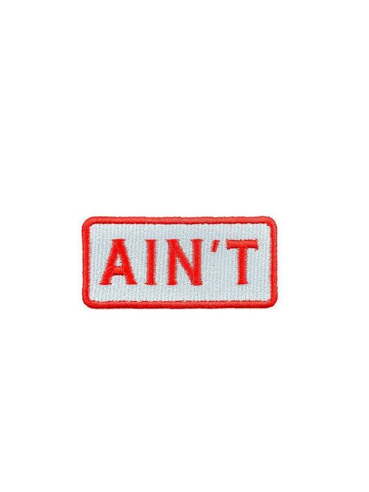 Embroidered patch with "AIN'T" text on a white background