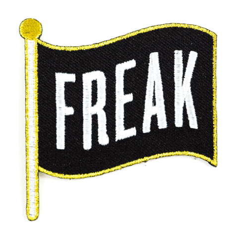 Embroidered patch with 'FREAK' text on a black background with yellow border and flag shape.