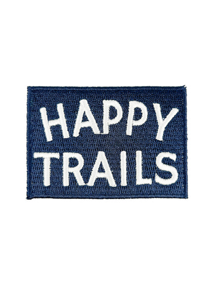 Navy blue patch with 'Happy Trails' text on a white background