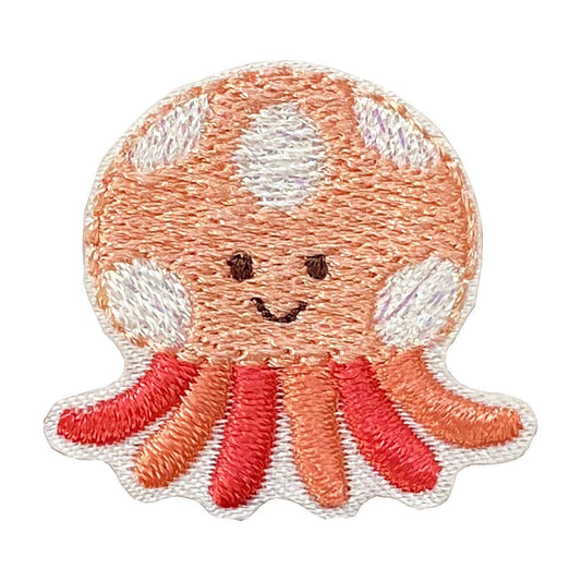 Embroidered patch of a smiling octopus with a white background