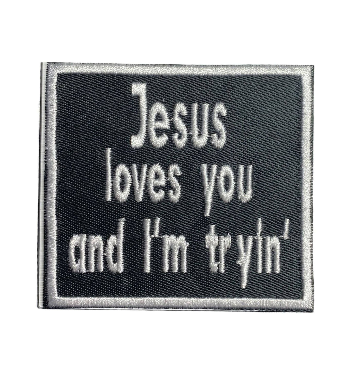 Embroidered patch with text 'Jesus loves you and I'm tryin'' on a black background