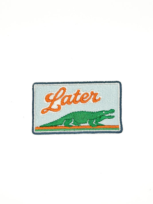 Embroidered patch with an alligator and 'Later' text on a white background