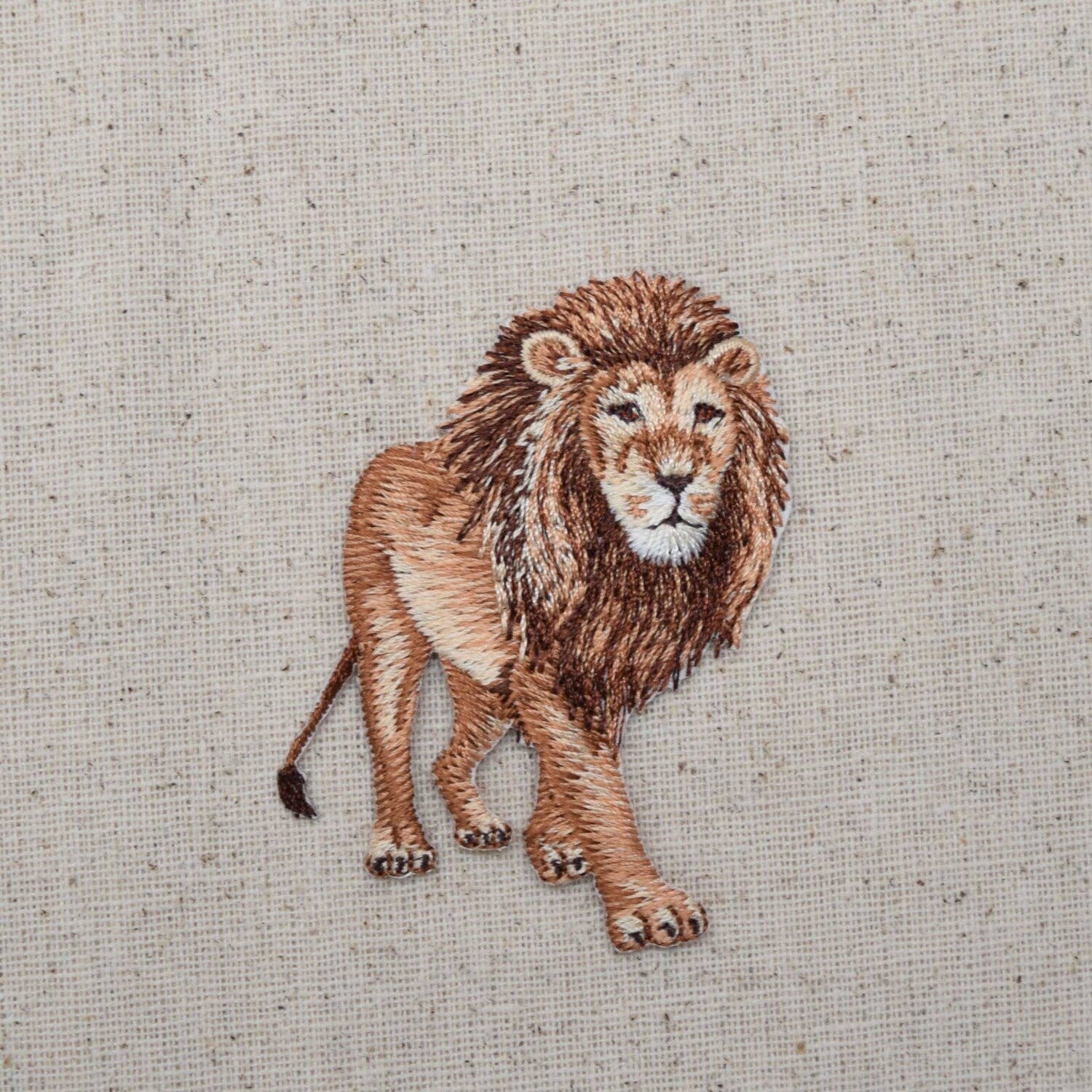 Embroidered lion on a textured fabric background