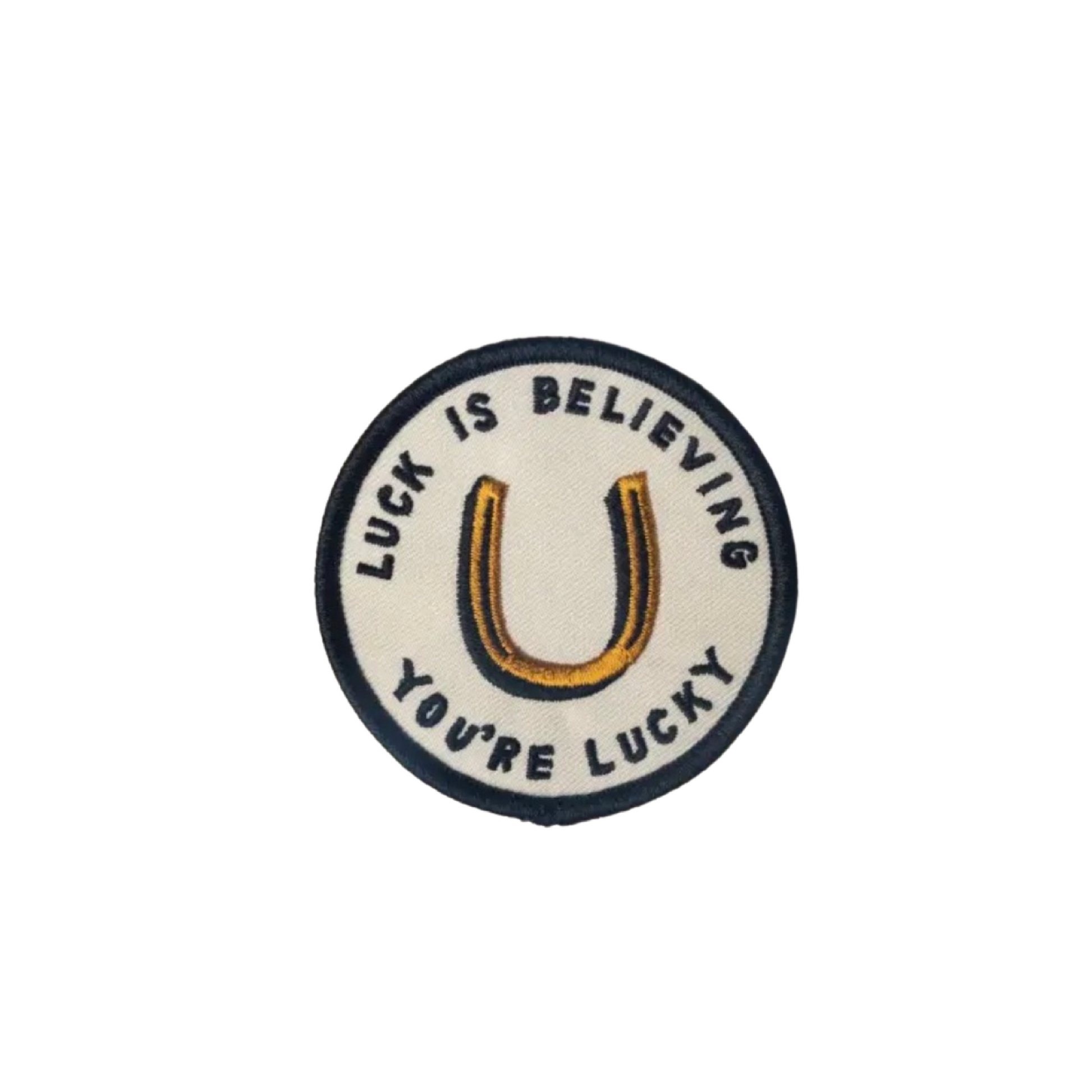 Circular patch with 'Luck is believing you're lucky' text and horseshoe symbol on a white background
