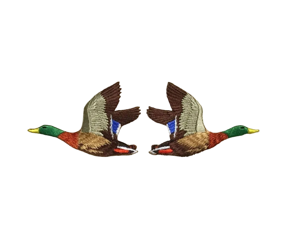 Two embroidered duck patches on a beige fabric background