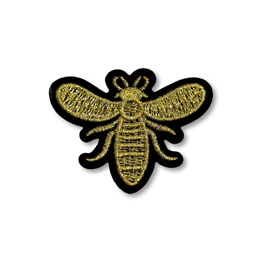 Gold bee patch on a white background