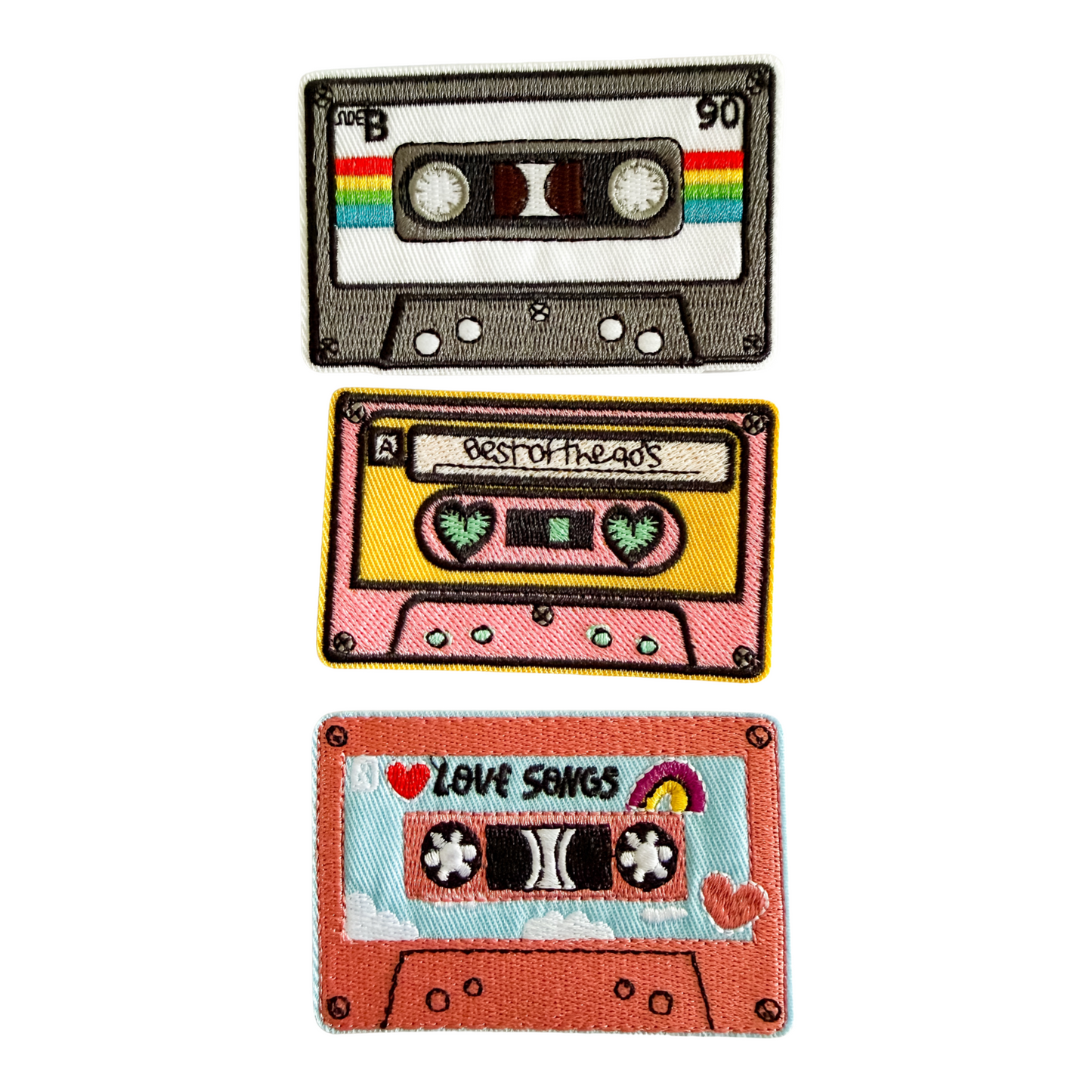 Three colorful cassette tape patches on a white background