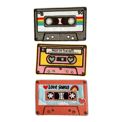 Three colorful cassette tape patches on a white background