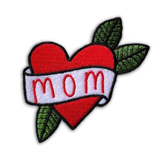 Heart-shaped patch with 'mom' text and green leaves on a white background
