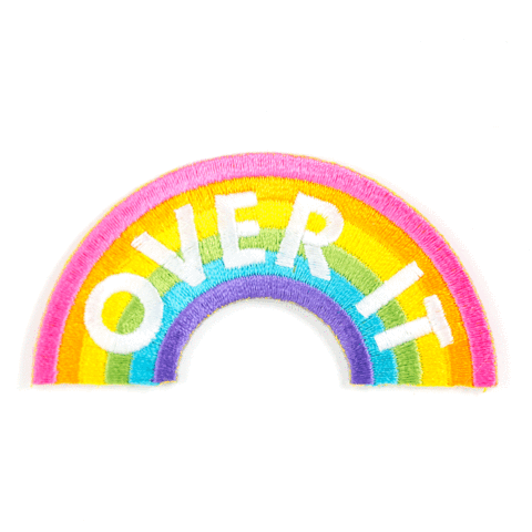 Colorful rainbow-shaped patch with 'COVER IT' text on a white background