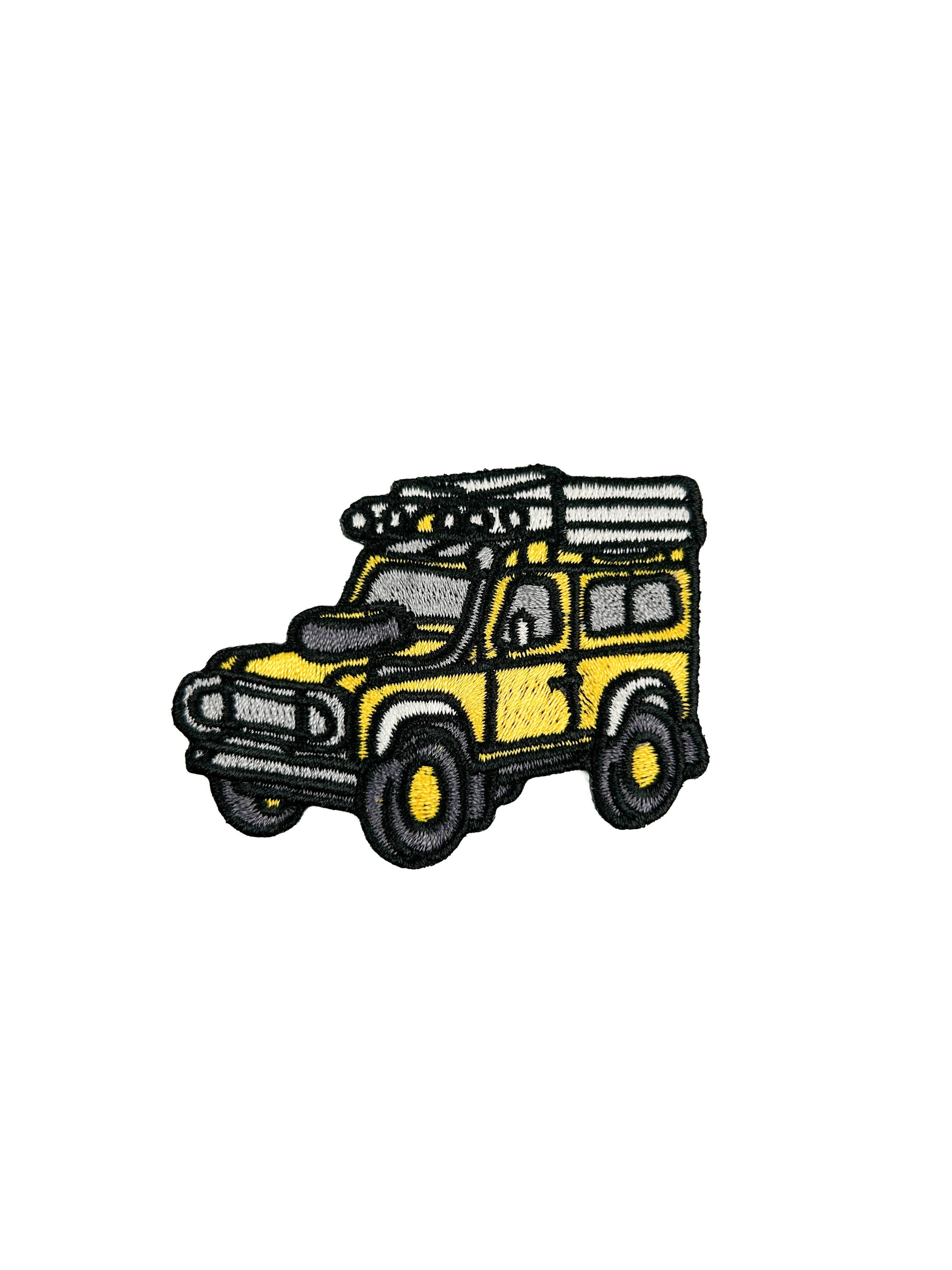 Embroidered patch of a yellow SUV with roof racks on a white background