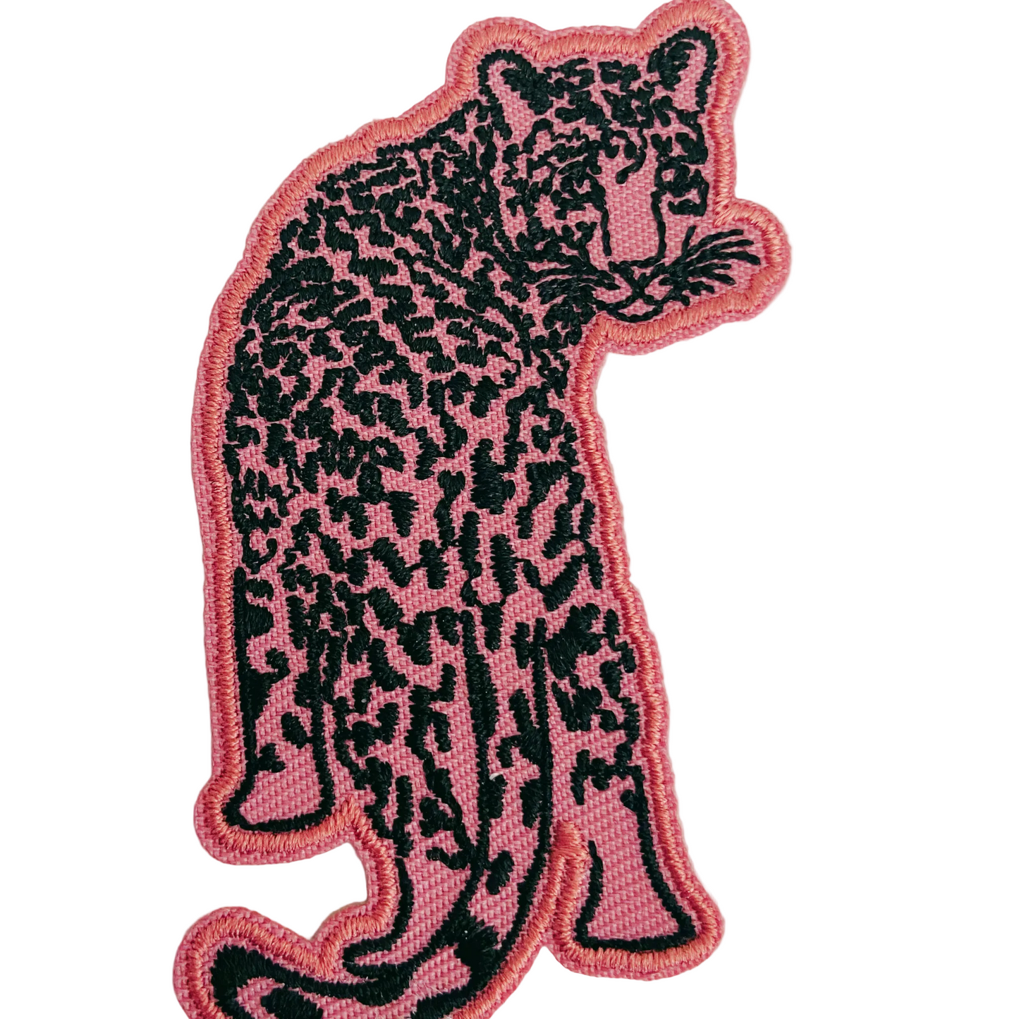 Pink and black panther patch on a light gray background