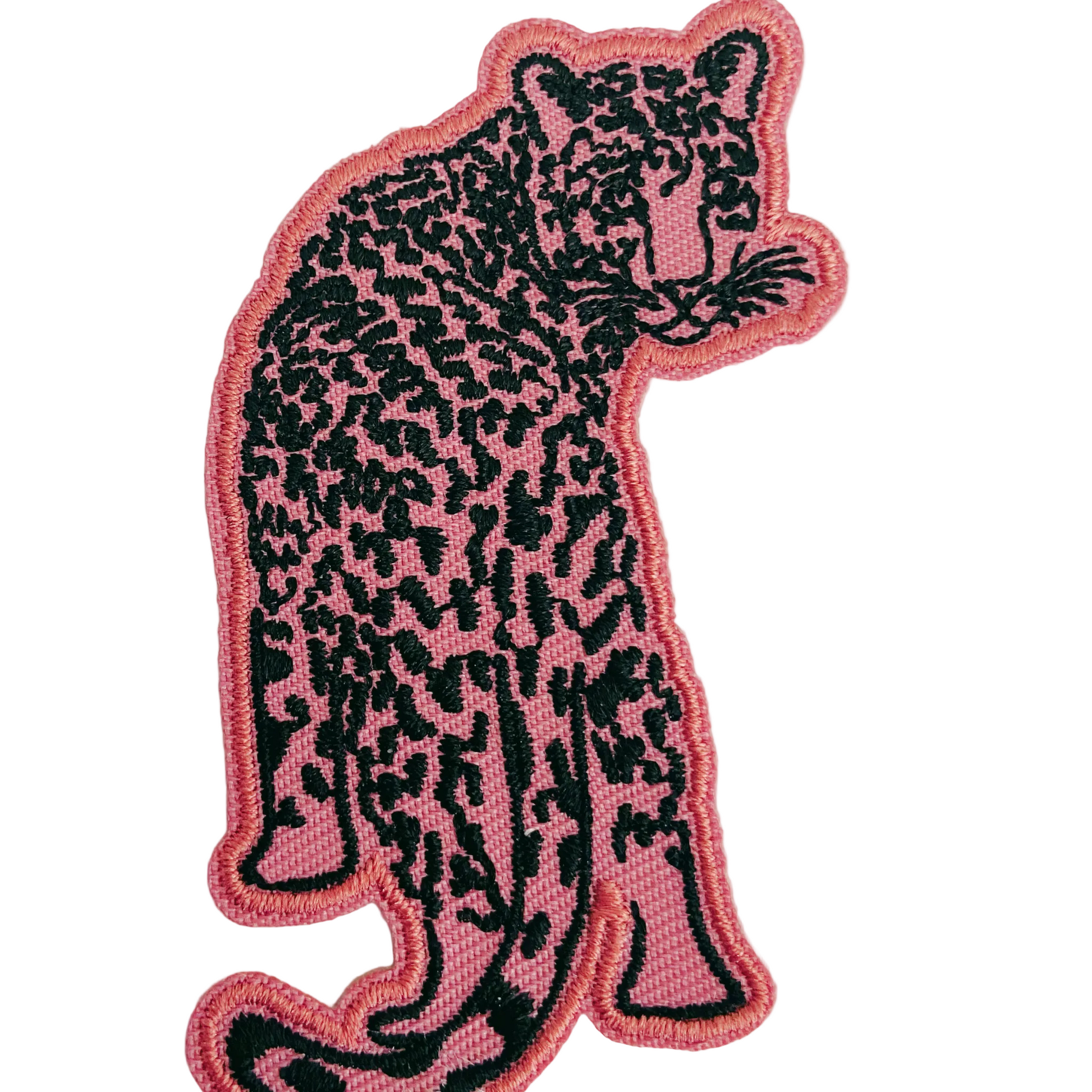 Pink and black panther patch on a light gray background