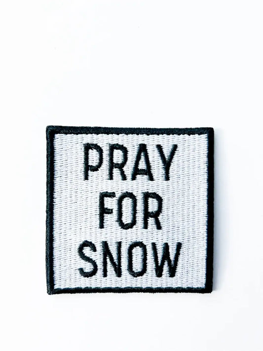 Patch with 'PRAY FOR SNOW' text on a white background