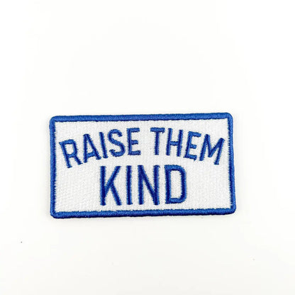 Patch with 'Raise Them Kind' text on a white background