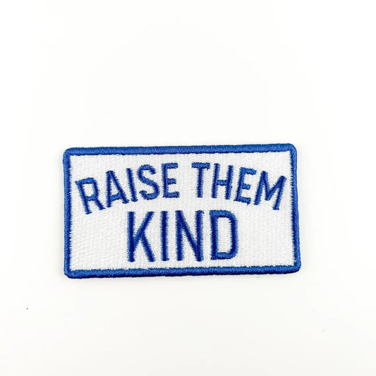 Patch with 'Raise Them Kind' text on a white background