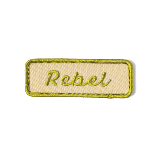 Patch with 'Rebel' text on a beige background