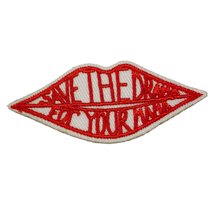 Red embroidered patch with text on a white background