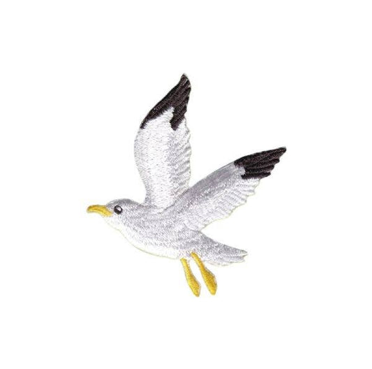 Toy seagull with open wings on a white background