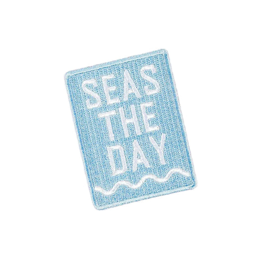 Blue sign with 'SEAS THE DAY' text on a beige background