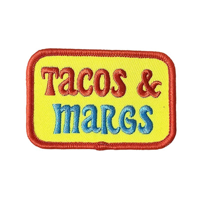 Embroidered patch with 'Tacos & margs' text on a yellow background