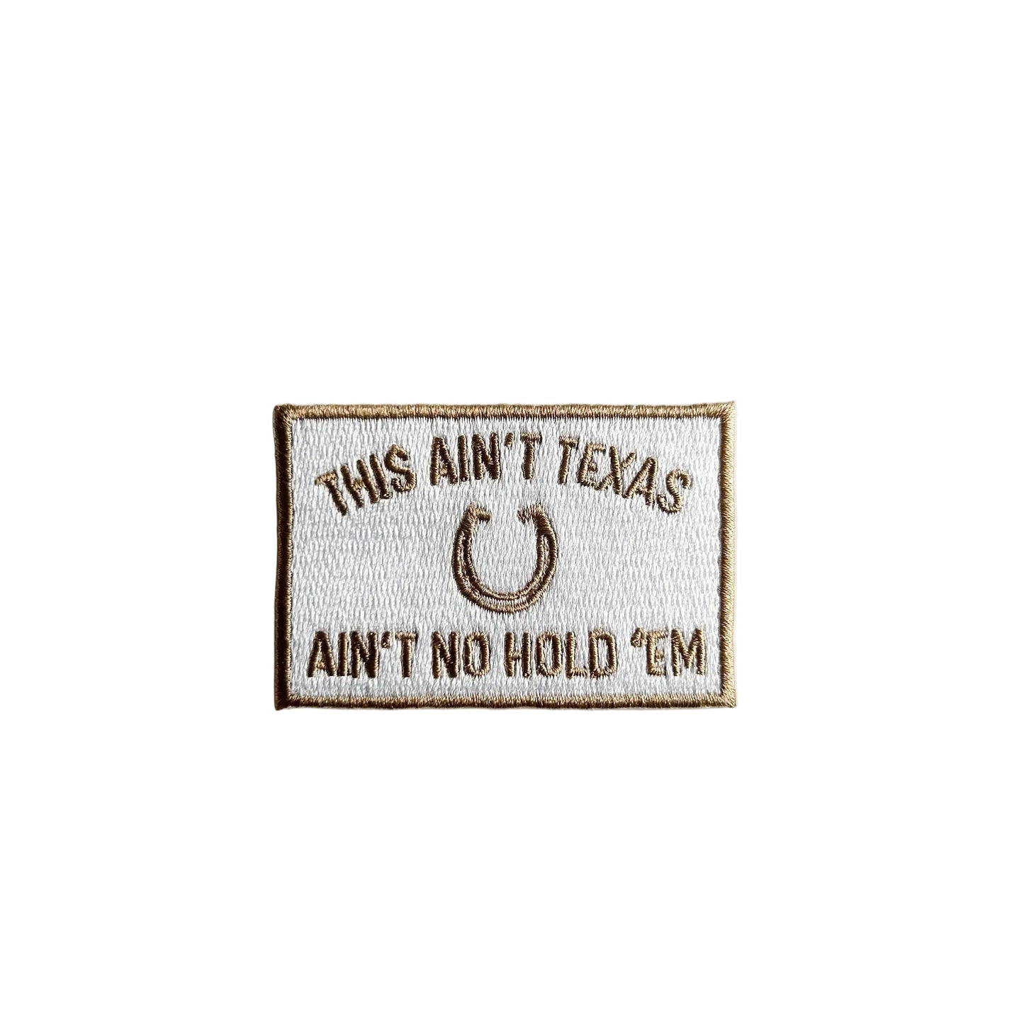 Embroidered patch with text 'This ain't Texas, ain't no hold 'em' on a white background