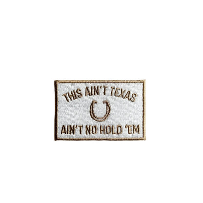 Embroidered patch with text 'This ain't Texas, ain't no hold 'em' on a white background