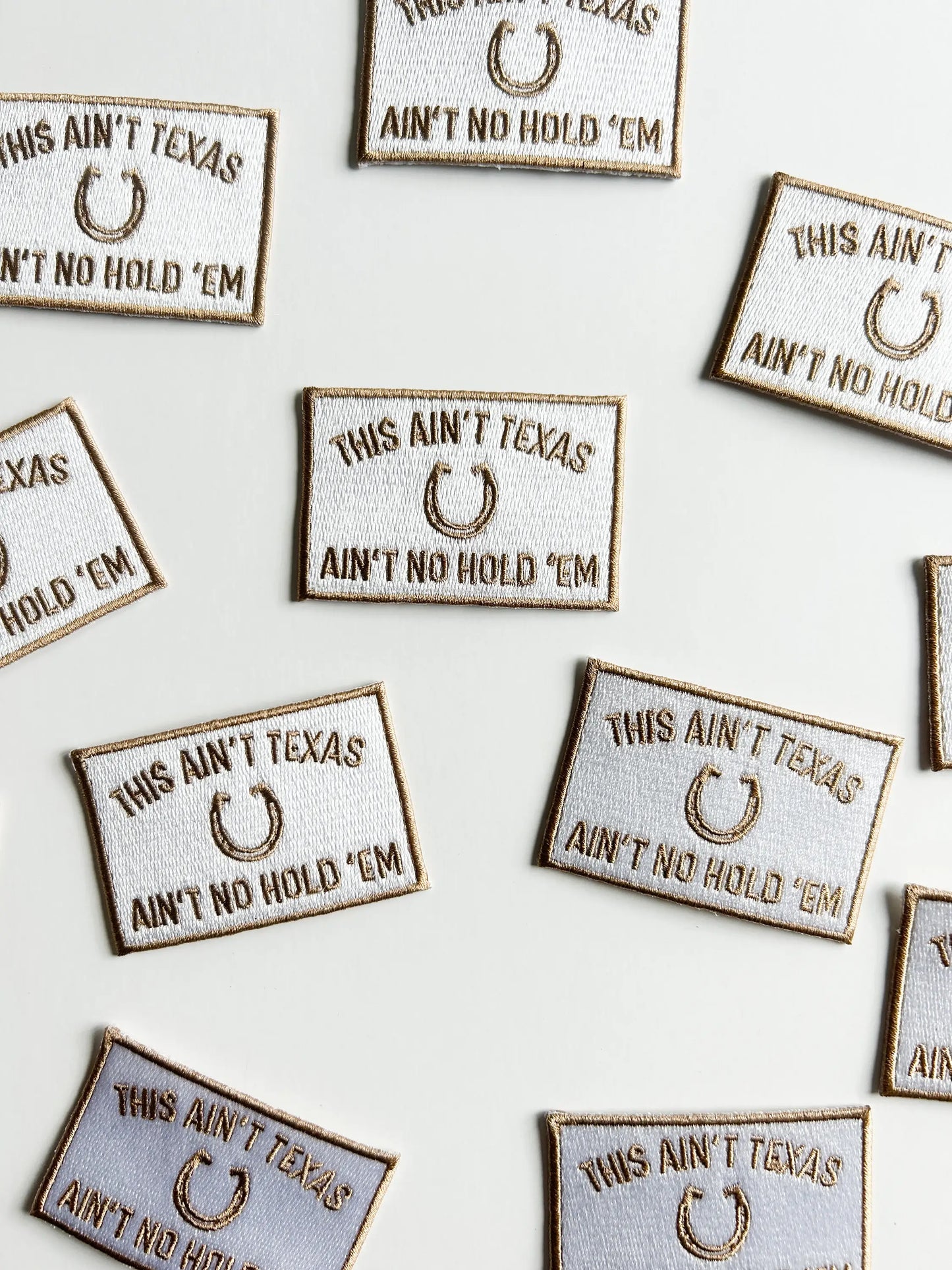 Embroidered patches with 'This Ain't Texas, Ain't No Hold 'Em' text on a white background