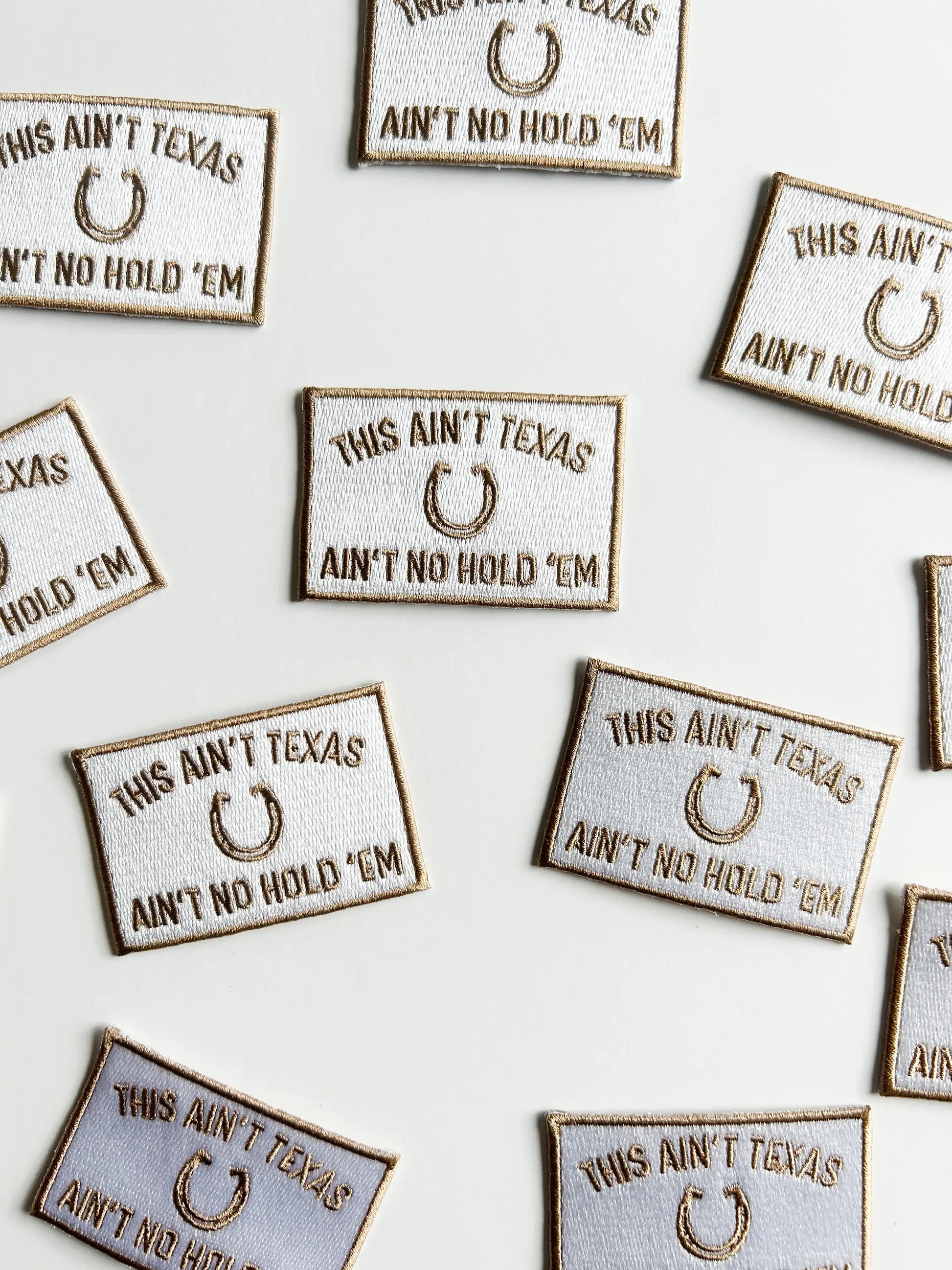Embroidered patches with 'This Ain't Texas, Ain't No Hold 'Em' text on a white background