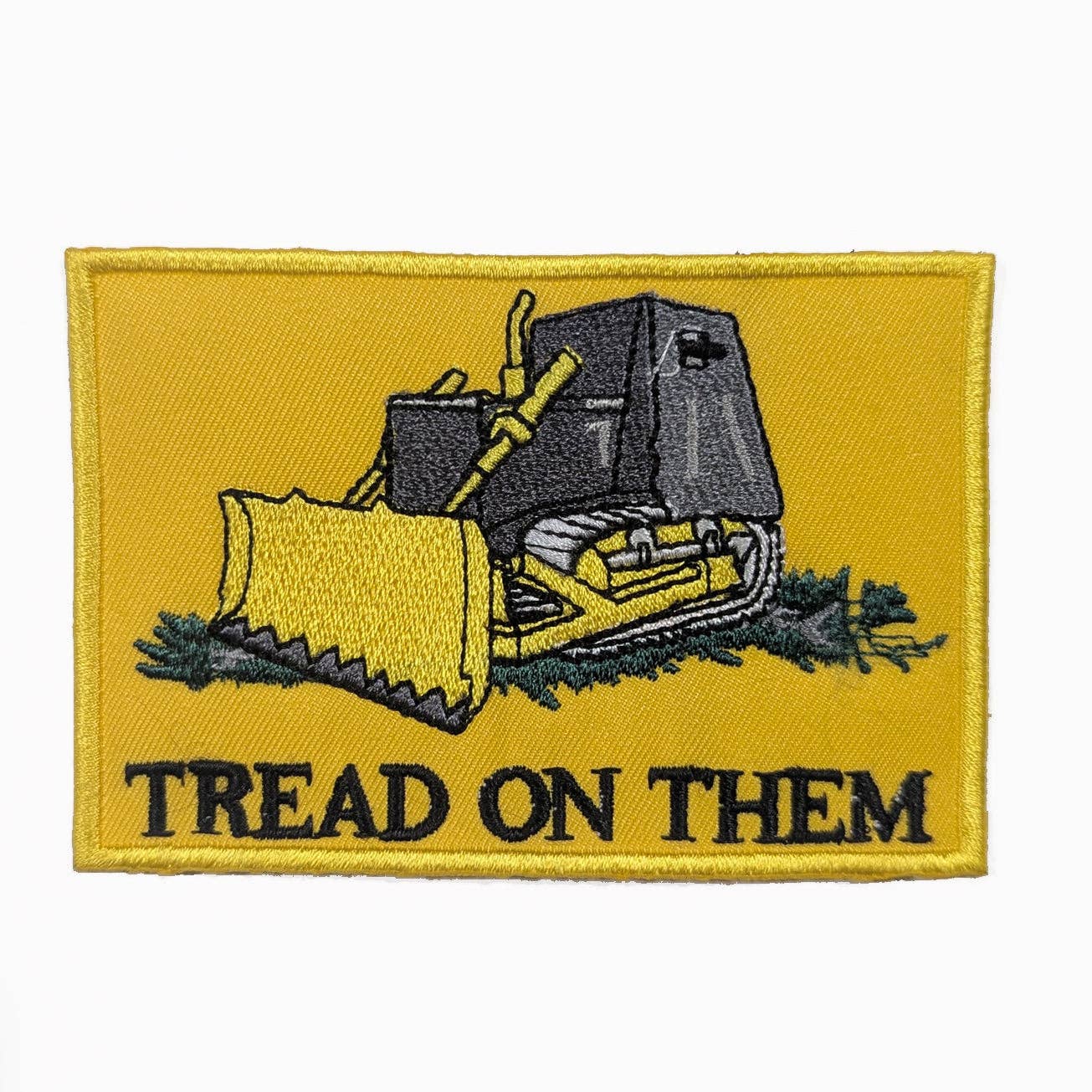 Patch with a bulldozer illustration and 'Tread on Them' text on a yellow background
