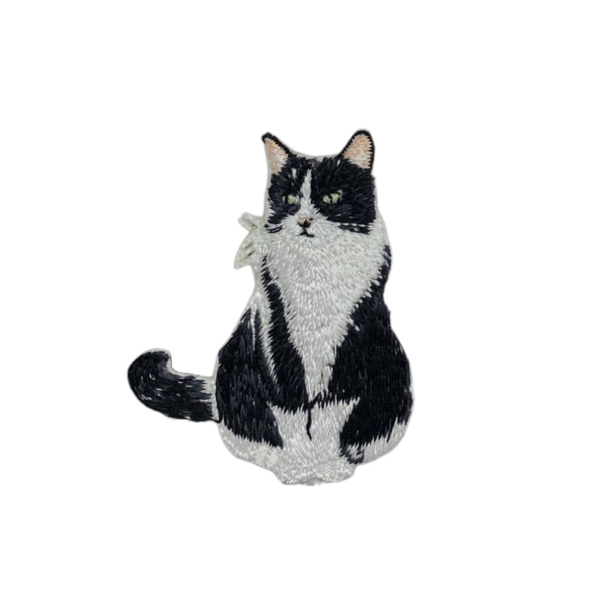 Black and white cat-shaped plush toy on a white background