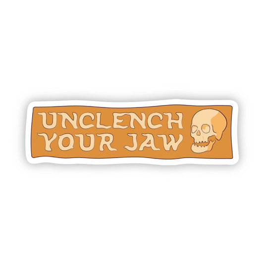 Sticker with 'Unclench Your Jaw' text and a skull design on an orange background
